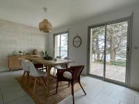 a dining room with a wooden table and chairs at Premium holiday home in top location with sea view, Plougasnou in Plougasnou