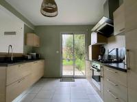 a kitchen with a sink and a door to a yard at Premium holiday home in top location with sea view, Plougasnou in Plougasnou