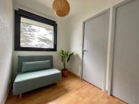 a room with a green chair and a window at Premium holiday home in top location with sea view, Plougasnou in Plougasnou