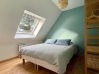 a bedroom with a bed and a window at Premium holiday home in top location with sea view, Plougasnou in Plougasnou