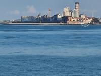 a large body of water with a city in the background at Rijksmonument Havenzicht, met zeezicht, ligging direct aan zee en centrum in Vlissingen