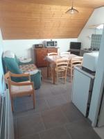 a kitchen and dining room with a table and chairs at Le Piolit in Prunières