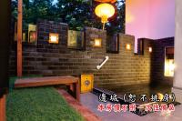 a brick wall with a bench and a light at Tingtau Villa in Lugu Lake