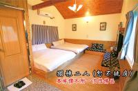 a small room with two beds in it at Tingtau Villa in Lugu Lake