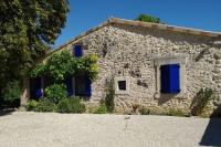 a stone house with blue shutters on it at La maison bleue in Grane