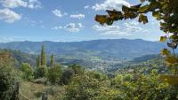 a view of a valley with mountains in the distance at La Peyreyre in Jaujac