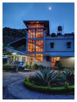 a building with a car parked in front of it at Sha Ri Loum Homestay in Shillong