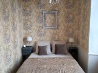 a bedroom with a bed and a picture on the wall at Gîte Bazouges-sur-le-Loir, 6 pièces, 10 personnes - FR-1-410-377 in Bazouges-sur-le-Loir