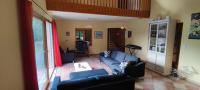 a living room with a blue couch and a table at La Peyreyre in Jaujac