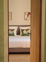 a bedroom with a bed with two pillows at Jardin Meurin in Tabanac