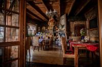 a dining room with tables and chairs and a chandelier at Oławian Hotel in Oława