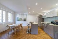 a kitchen with a table and chairs in a room at Renovated apartment 80m2 6P 2BR - Cannes Palm Beach in Cannes