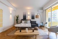 a living room with a couch and a table at Renovated apartment 80m2 6P 2BR - Cannes Palm Beach in Cannes