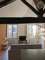 a large bedroom with a large bed and windows at Bordeaux Chéri in Bordeaux