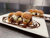 Dos platos de postre en un plato con salsa de chocolate. en L'auberge fleurie, en Heilly