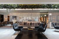 a lobby with a couch and chairs and tables at Le Méridien Vienna in Vienna