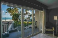a room with a balcony with a view of the ocean at San Juan Marriott Resort and Stellaris Casino in San Juan