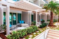 a resort patio with chairs and palm trees at San Juan Marriott Resort and Stellaris Casino in San Juan