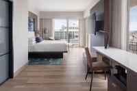 a hotel room with a bed and a desk and a bedroom at San Juan Marriott Resort and Stellaris Casino in San Juan