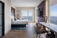 a hotel room with a bed and a view of the ocean at San Juan Marriott Resort and Stellaris Casino in San Juan