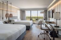 a hotel room with two beds and a desk at Orlando World Center Marriott in Orlando