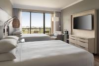 a hotel room with two beds and a flat screen tv at Orlando World Center Marriott in Orlando