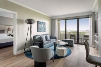 a hotel room with a bed and a couch and a table at Orlando World Center Marriott in Orlando