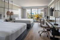 a hotel room with two beds and a desk at Orlando World Center Marriott in Orlando