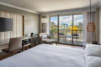 a hotel room with a large bed and a balcony at Orlando World Center Marriott in Orlando