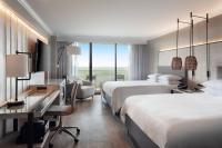 a hotel room with two beds and a desk at Orlando World Center Marriott in Orlando