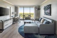 a living room with a couch and a television at Orlando World Center Marriott in Orlando