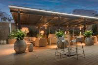 a patio with chairs and a pavilion with plants at SH Colón Valencia in Valencia