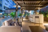 a patio with furniture and a bar on a building at SH Colón Valencia in Valencia