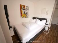 A bed or beds in a room at Astoria Apartments