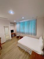 a bedroom with a white bed and a window at Blue Sea Inn in Eluan