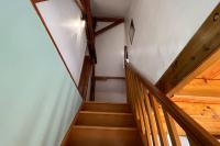 a set of wooden stairs in a house at La Reinette du Verger 9 d&#39;Arry 1 in Arry