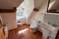 a bathroom with a white toilet and a sink at La Reinette du Verger 9 d&#39;Arry 1 in Arry