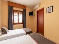 Łóżko lub łóżka w pokoju w obiekcie HOSTAL-RESTAURANTE EL PAISANO