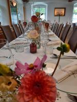 a long table with flowers on top of it at Restaurant Hotel Schrott in Kaibing