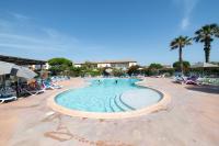 a swimming pool at a resort with people in it at SOWELL RESIDENCES Les Sablons in Le Grau-du-Roi
