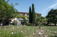 a garden in front of a house at SOWELL RESIDENCES Les Sablons in Le Grau-du-Roi