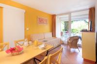 a living room with a table and a dining room at SOWELL RESIDENCES Les Sablons in Le Grau-du-Roi