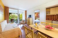 a living room with a kitchen and a dining room at SOWELL RESIDENCES Les Sablons in Le Grau-du-Roi