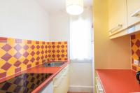 a colorful kitchen with a sink and a window at SOWELL RESIDENCES Les Sablons in Le Grau-du-Roi