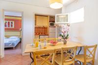 a kitchen and dining room with a table and chairs at SOWELL RESIDENCES Les Sablons in Le Grau-du-Roi