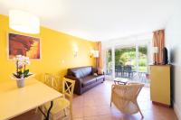 a living room with a couch and a table at SOWELL RESIDENCES Les Sablons in Le Grau-du-Roi