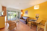 a living room with a couch and a table at SOWELL RESIDENCES Les Sablons in Le Grau-du-Roi