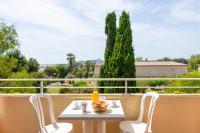 a table and chairs on a balcony with a view at SOWELL RESIDENCES Les Sablons in Le Grau-du-Roi
