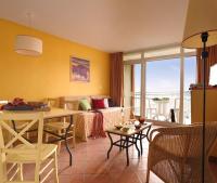 a living room with a couch and a table at SOWELL RESIDENCES Les Sablons in Le Grau-du-Roi