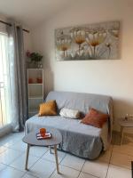 a living room with a couch and a table at Duplex Raphael- Wi-fi et parking privé in Toulon